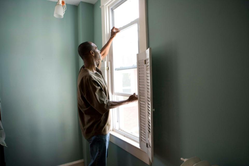 Person cleaning a window with a cloth.